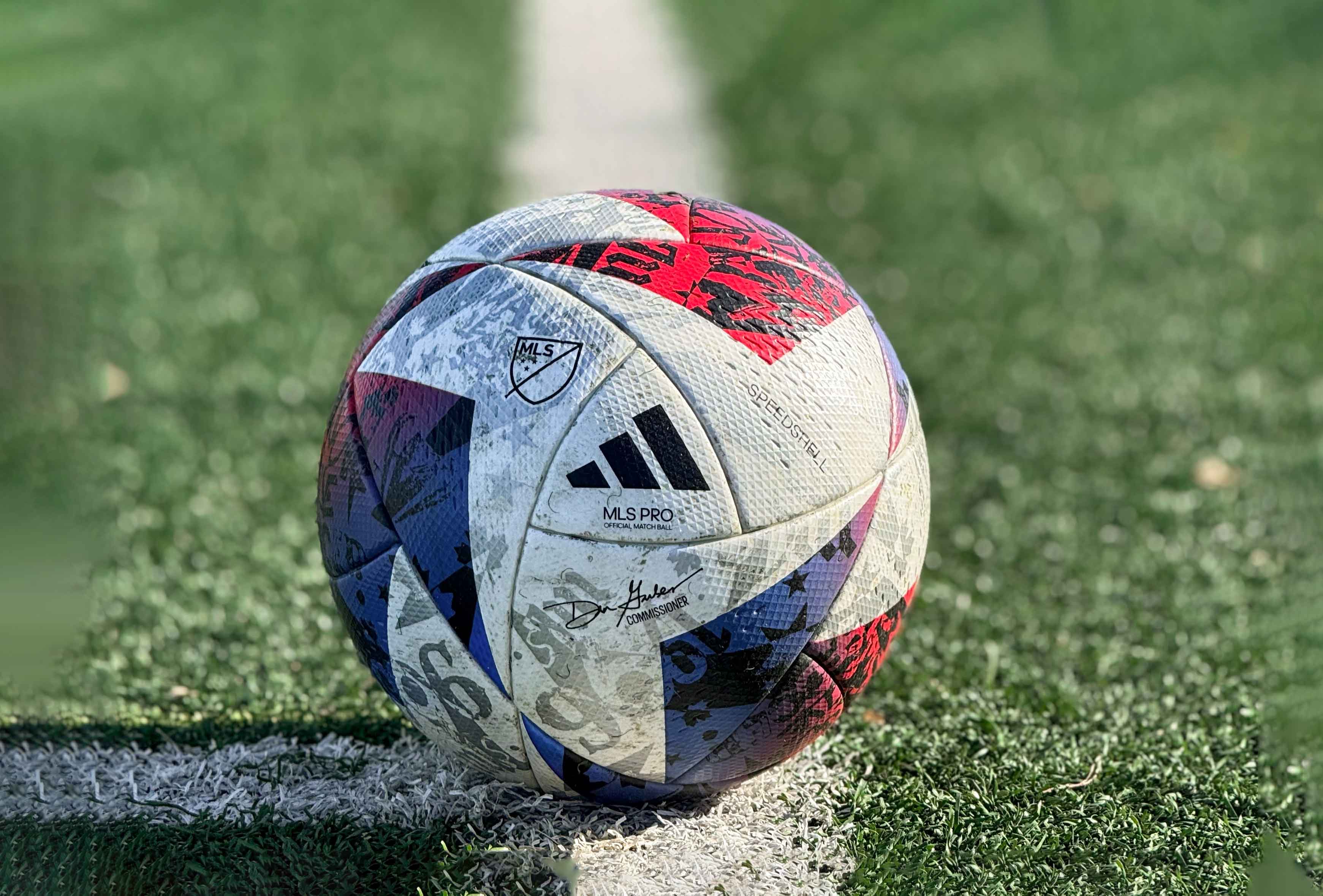 adidas soccer ball on a soccer field 1