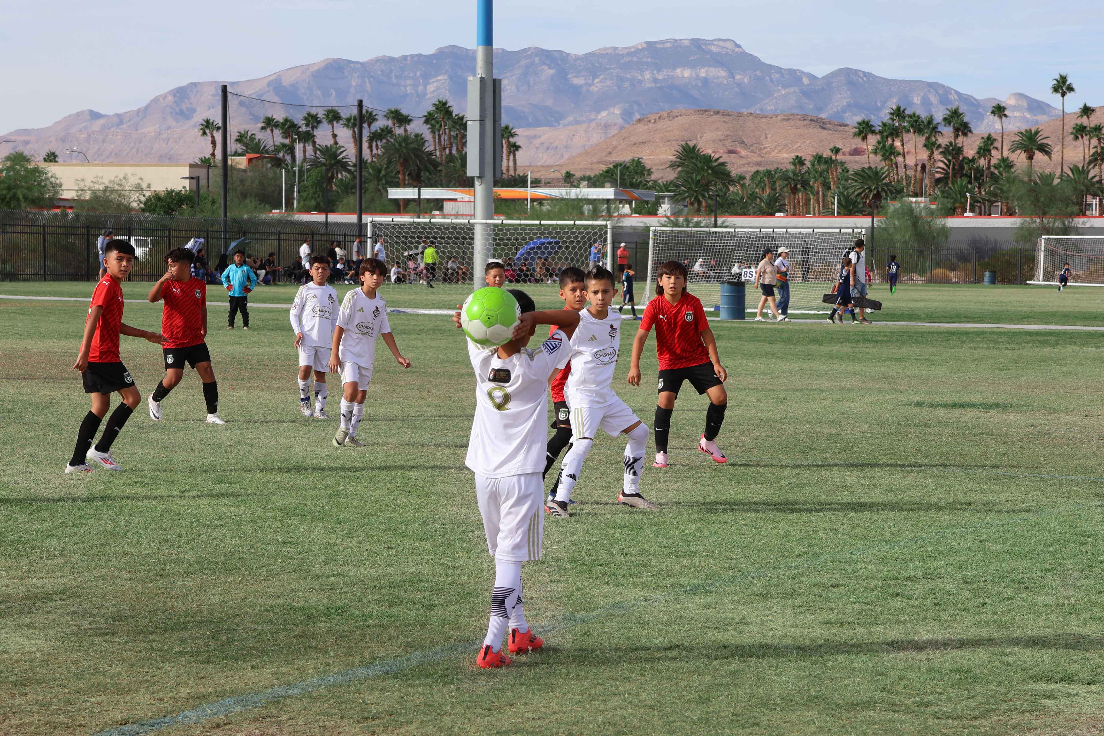 kid doing a side hand throw on a soccer match