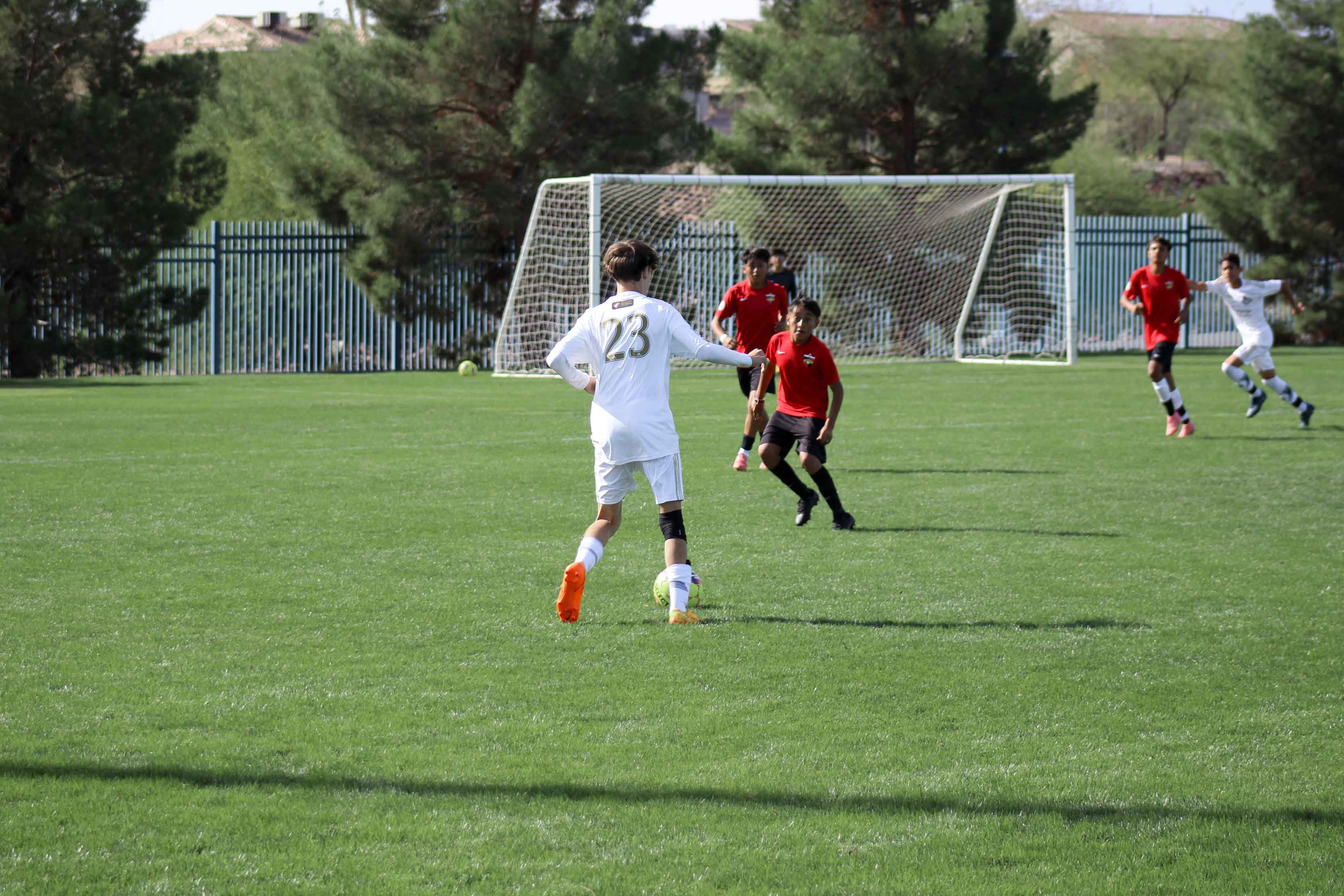 kid dribling a ball passed a defender