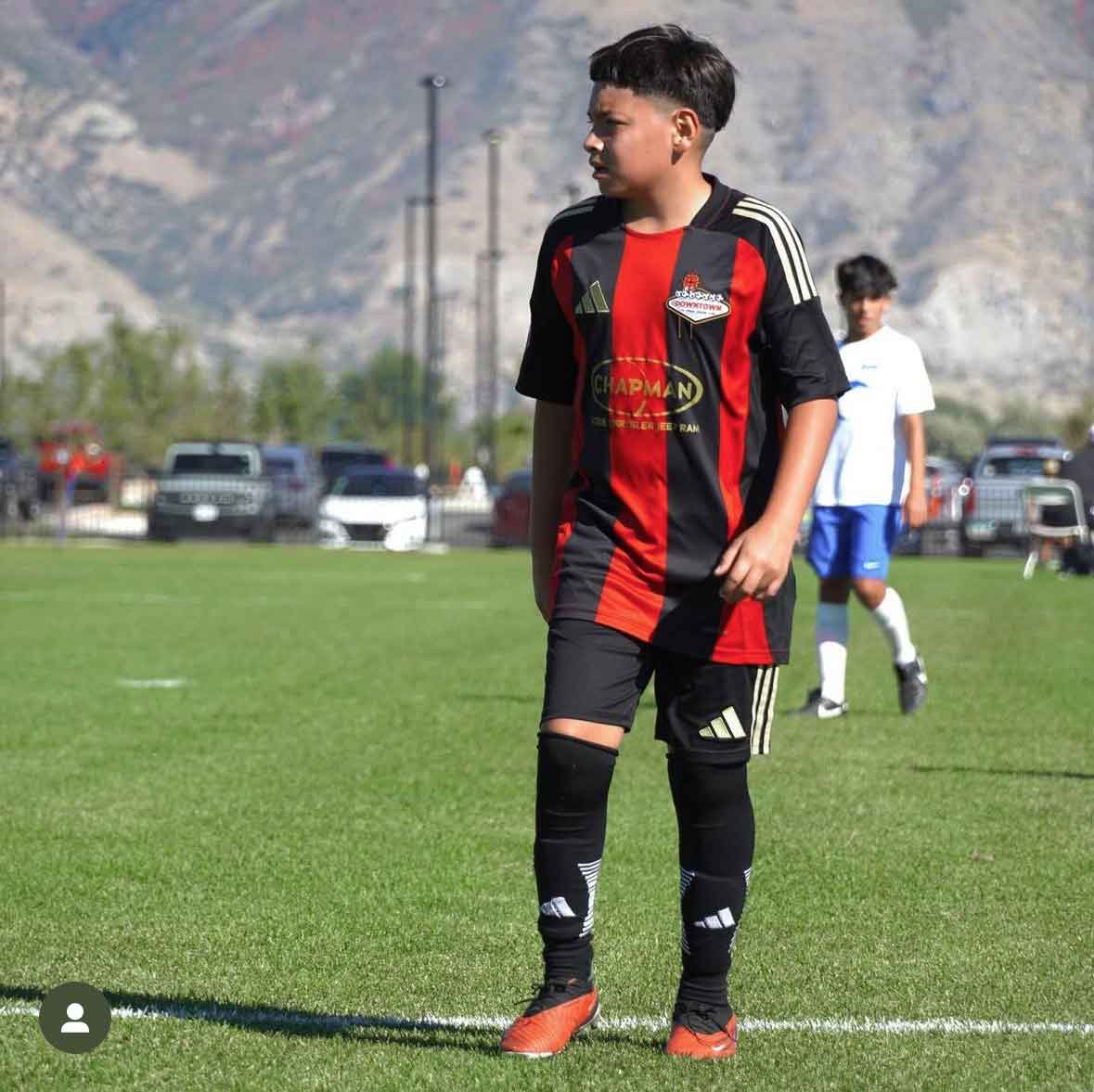 kid standing on a soccer field