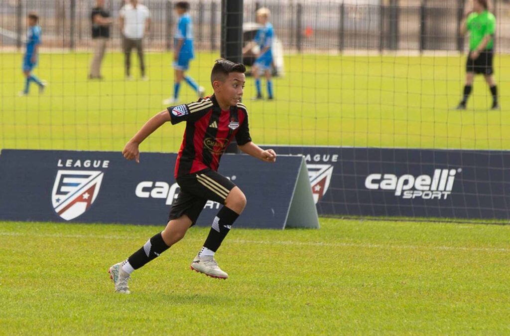kid running to tackle a ball